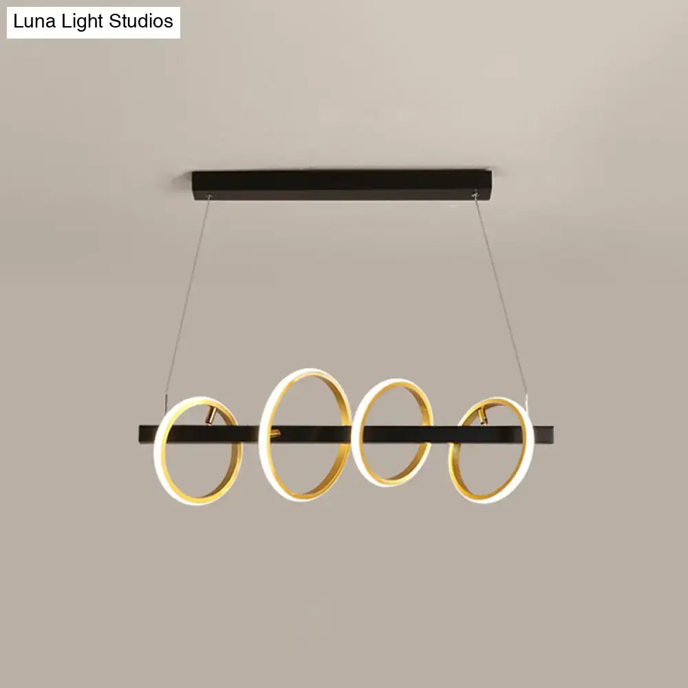 Modern black and gold metal ceiling pendant with simple circles design and illuminated rings for dining room island lighting