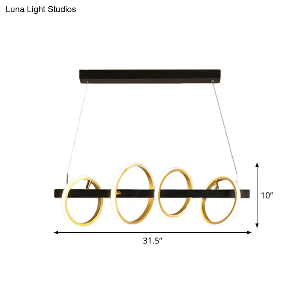 Modern black and gold metal ceiling pendant with simple circles design and four glowing heads for dining room island lighting