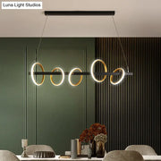 Modern black and gold metal ceiling pendant with simple circles design and warm light for dining room island illumination