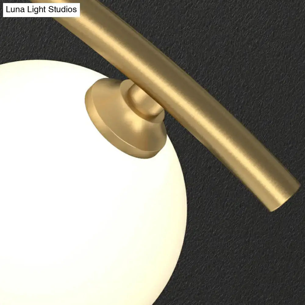 Decorbites gold milk ball glass pendant lighting featuring a gold-toned metal rod and off-white glass shade for minimalist wavy ceiling spaces