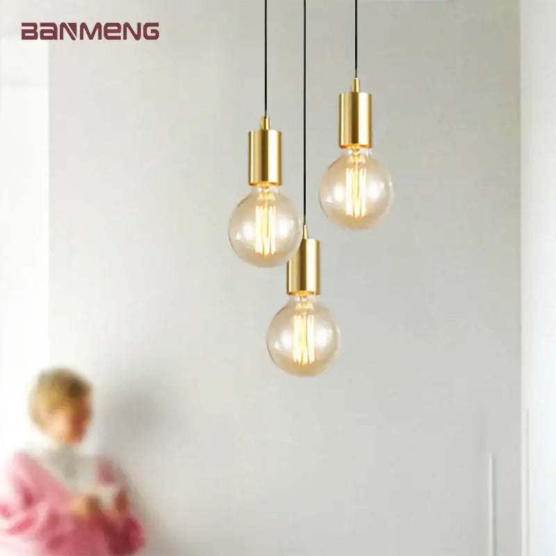 Gold modern pendant light by decorbites featuring clear glass bulb housings and visible filament bulbs for dining room use