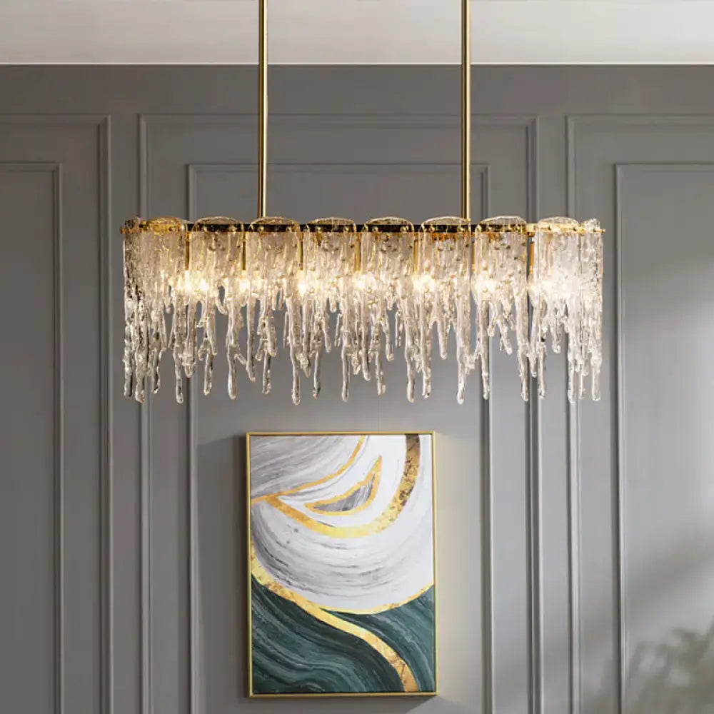 Gold-toned decorbites™ oval island ceiling light with clear crystal icicle elements and seven bulbs in minimalist design