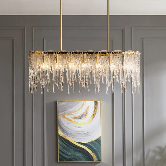 Gold-toned decorbites™ oval island ceiling light with clear crystal icicle elements and seven bulbs in minimalist design