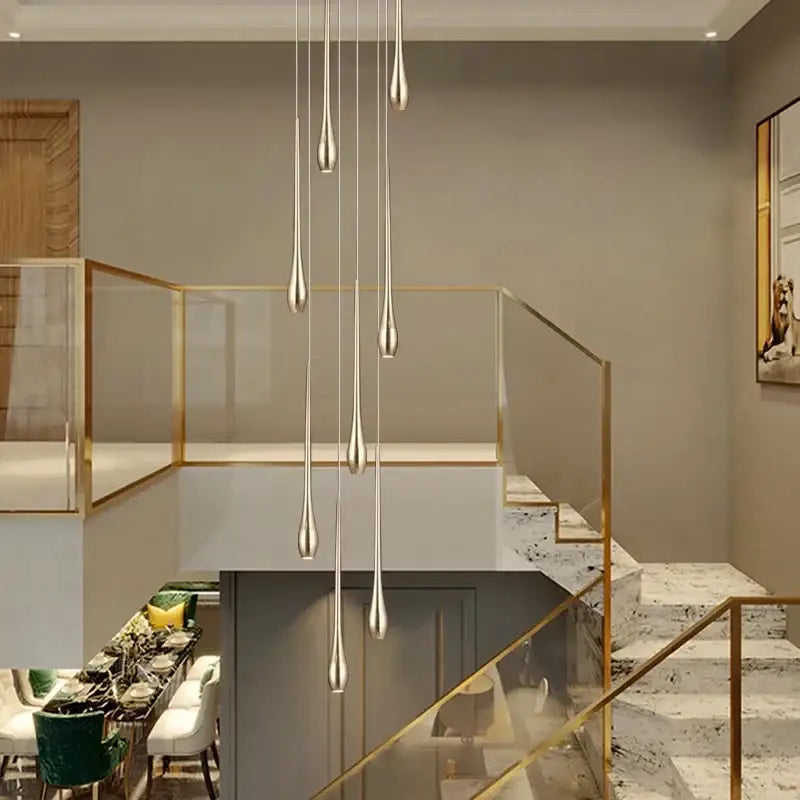 Modern silver teardrop pendant lights complement the decorbites gold-plated duplex teardrop chandelier living room light