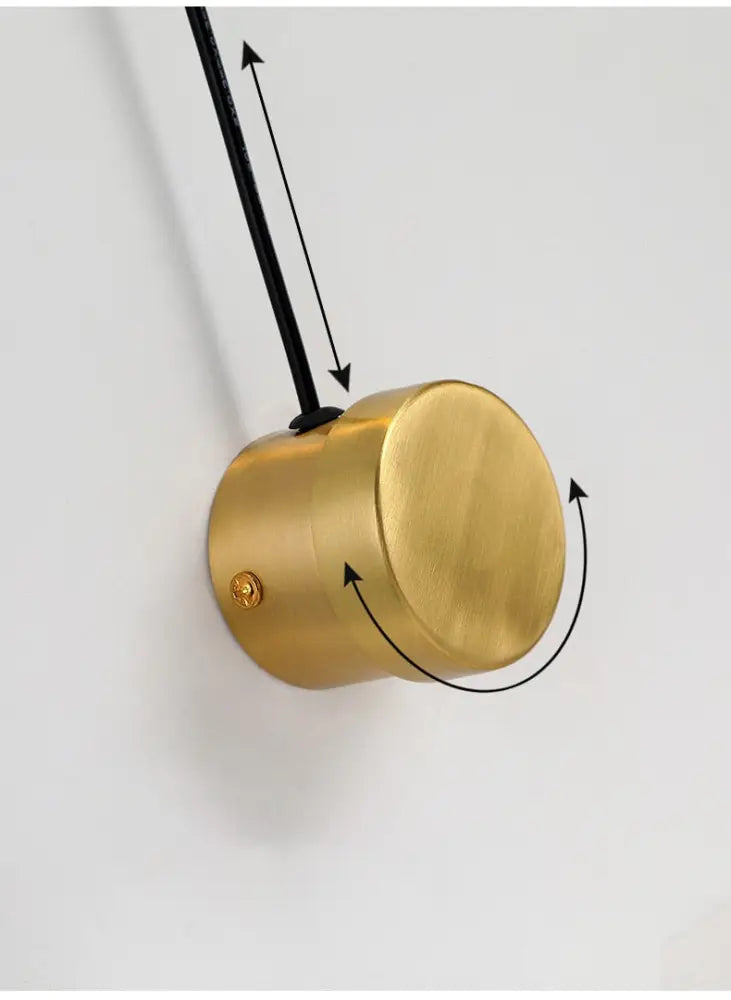 Decorbites gold wall lamp with dimmer switch featuring a brass cylindrical pendant design with matte finish and black cord