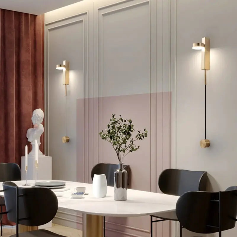 DecorBites™ gold wall lamp with dimmer switch features modern gold-toned wall lamps with sleek cylindrical shades