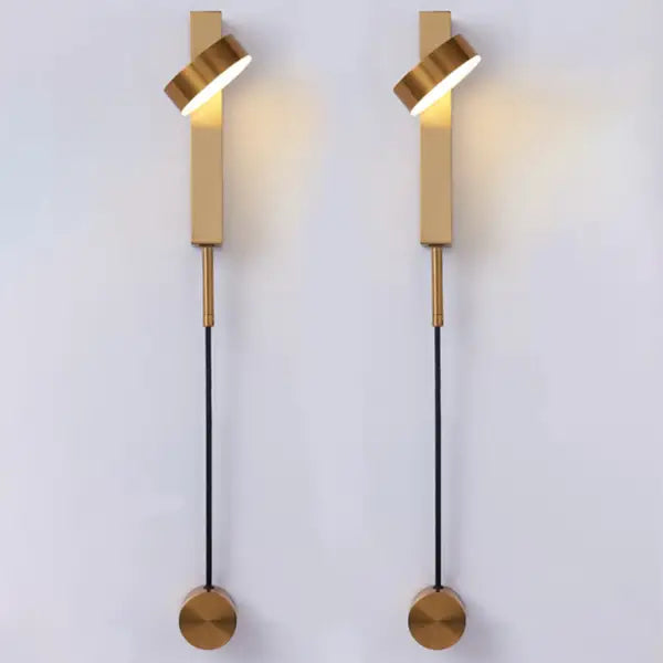 Pair of DecorBites™ gold wall lamps with dimmer switch featuring sleek twisted cylindrical shades and circular base plates