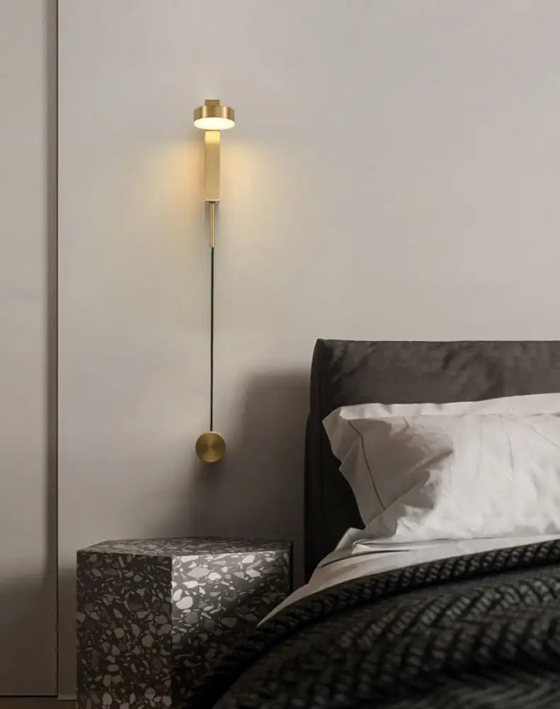 Gold-toned DecorBites™ wall lamp with dimmer switch featuring a sleek cylindrical top and spherical base design