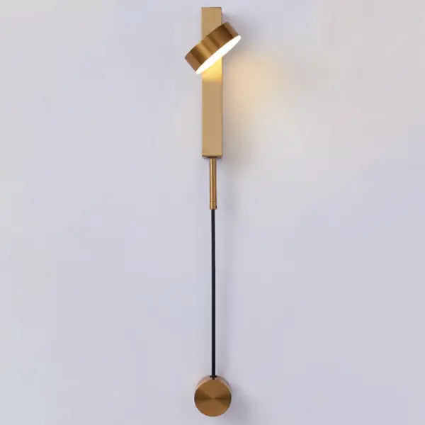 DecorBites gold wall lamp with dimmer switch featuring a sleek twisted cylindrical head and circular base in gold tone