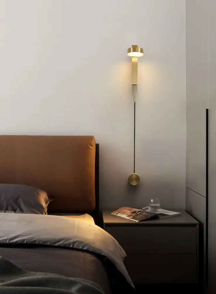 Gold-toned wall lamp with dimmer switch featuring sleek cylindrical body and circular base by DecorBites™ wall lamps