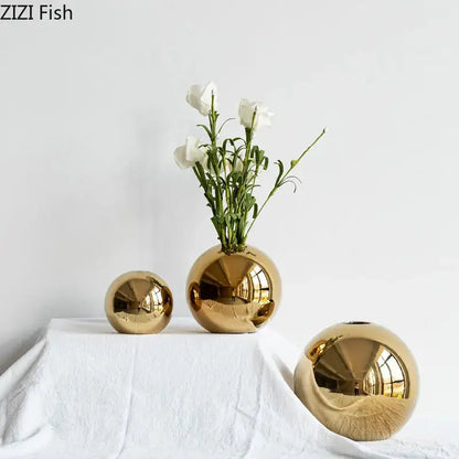 Decorbites™ golden ball ceramic vases in shiny gold with varying sizes one holding white flowers for home decor