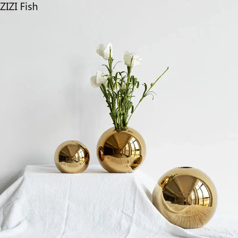 Decorbites™ golden ball ceramic vases in shiny gold with varying sizes one holding white flowers for home decor