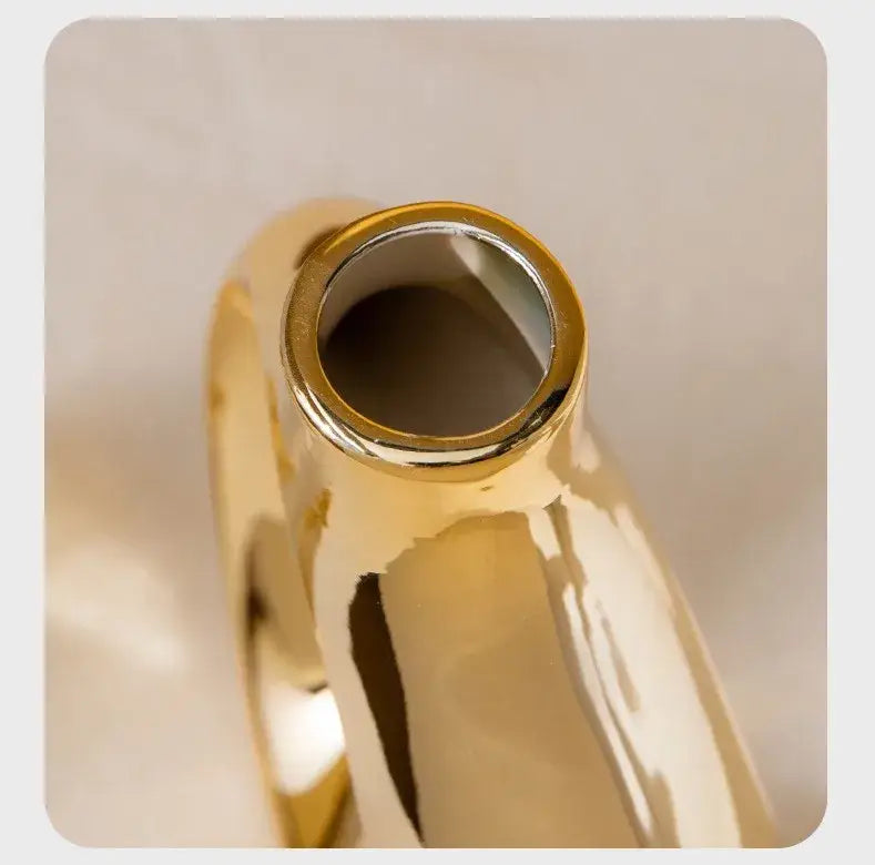 DecorBites™ golden flower vase made of ceramic with a sleek glossy finish and smooth curved contours for home decor