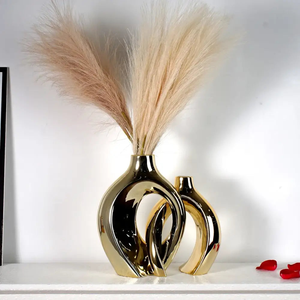 DecorBites™ golden flower vase featuring a sleek golden ceramic design with abstract curves and reflective surface