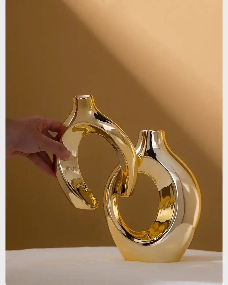 DecorBites golden flower vase featuring golden glossy ceramic with sleek modern curves and interlocking ring design