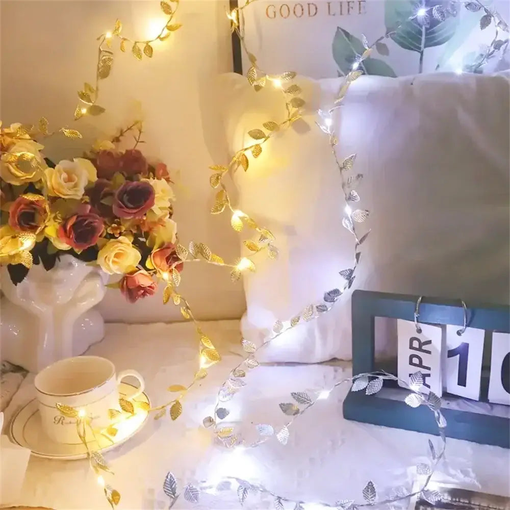 DecorBites™ golden silver fairy lights with tiny leaves adorn a cozy bedroom with warm white led string lights