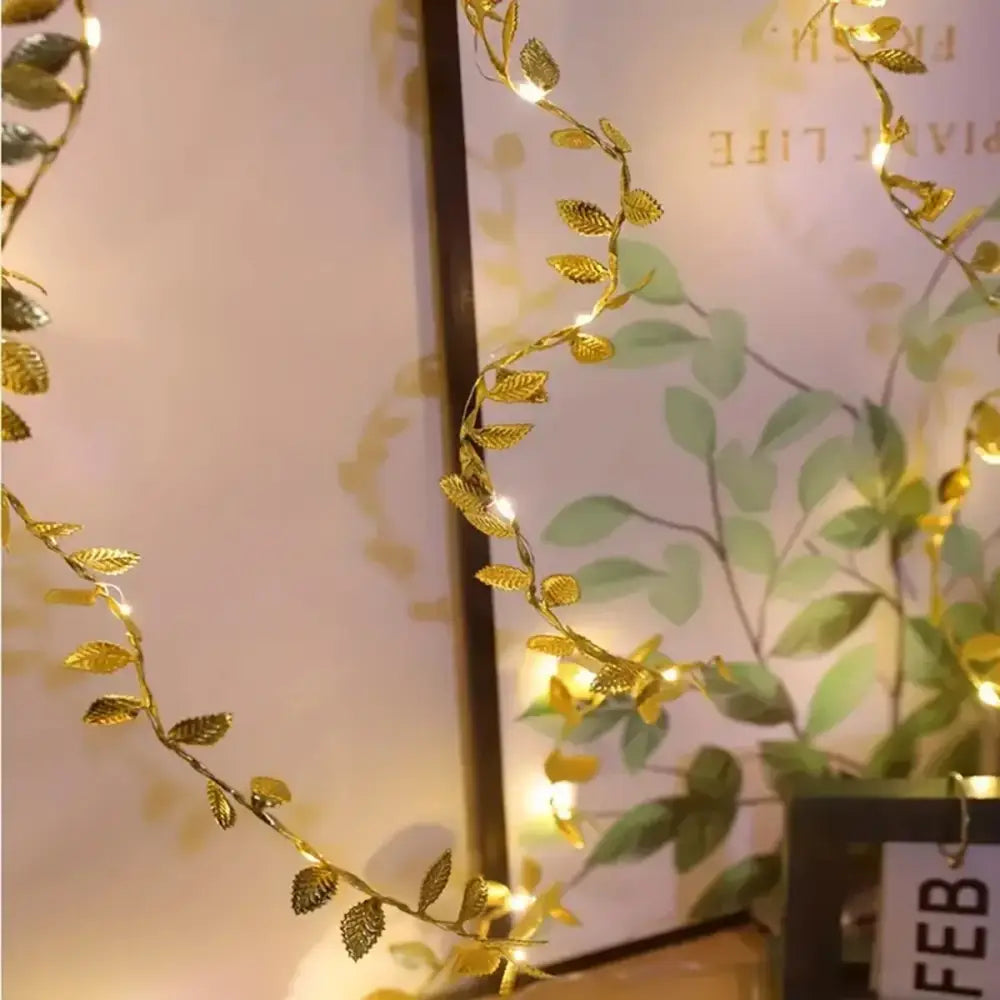 Decorbites™ golden silver fairy lights with tiny golden leaf-shaped bulbs providing warm glowing illumination for events