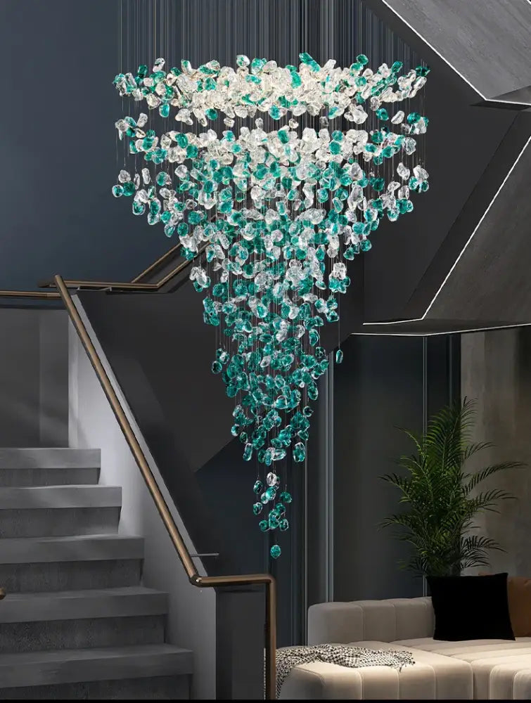 A decorbites™ green crystal stone chandelier featuring cascading clear and teal crystal beads suspended from a dark ceiling