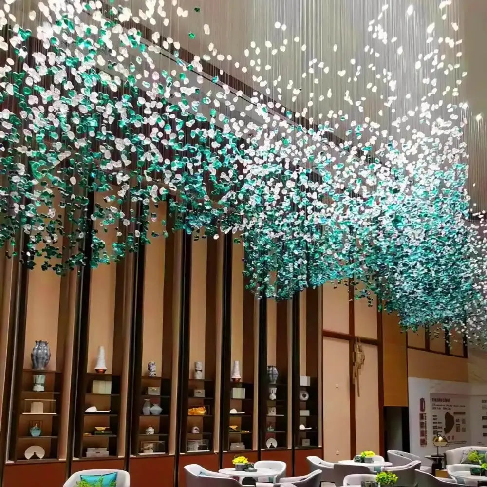 Cascading chandelier with translucent green crystal stone beads and white glass for modern spaces by decorbites