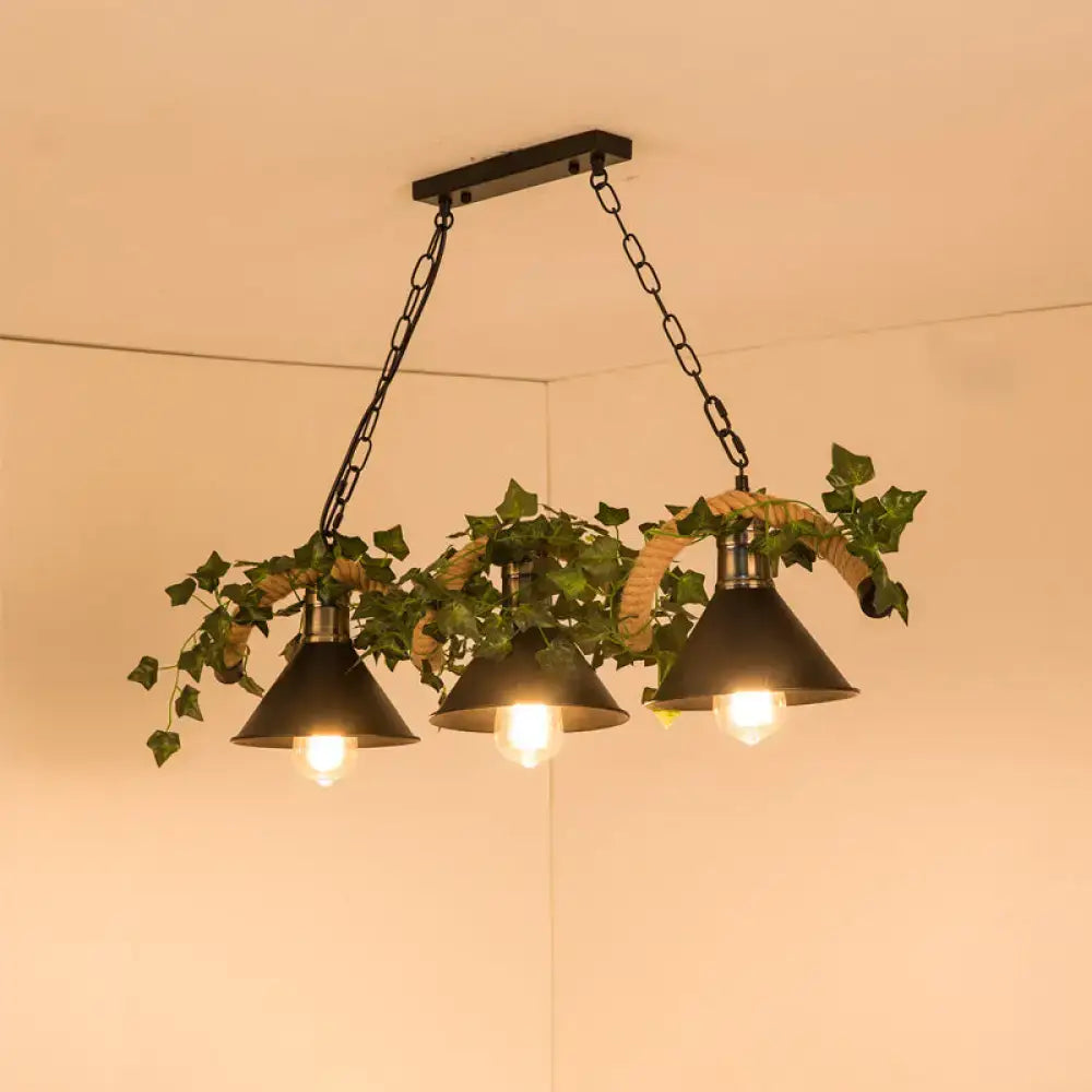 Black metal island light with three barrel flared conical shades, green faux plant ivy, and woven rope accents