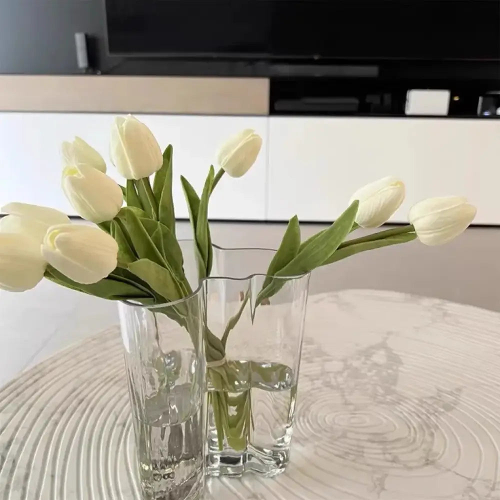 DecorBites™ green glass vase set features two clear glass vases with textured and wavy rim designs holding white tulips
