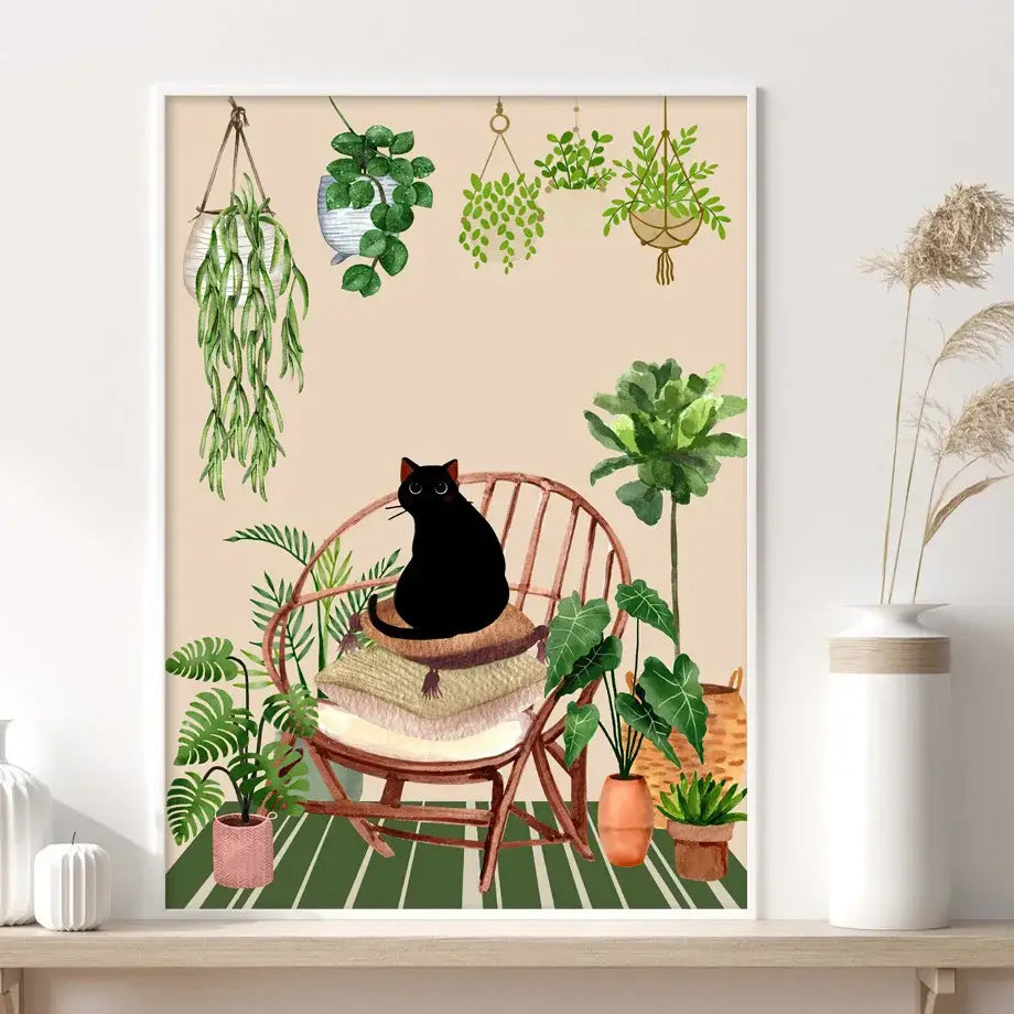A framed canvas wall art by decorbites featuring a black cat in a wicker chair surrounded by green plants black decor