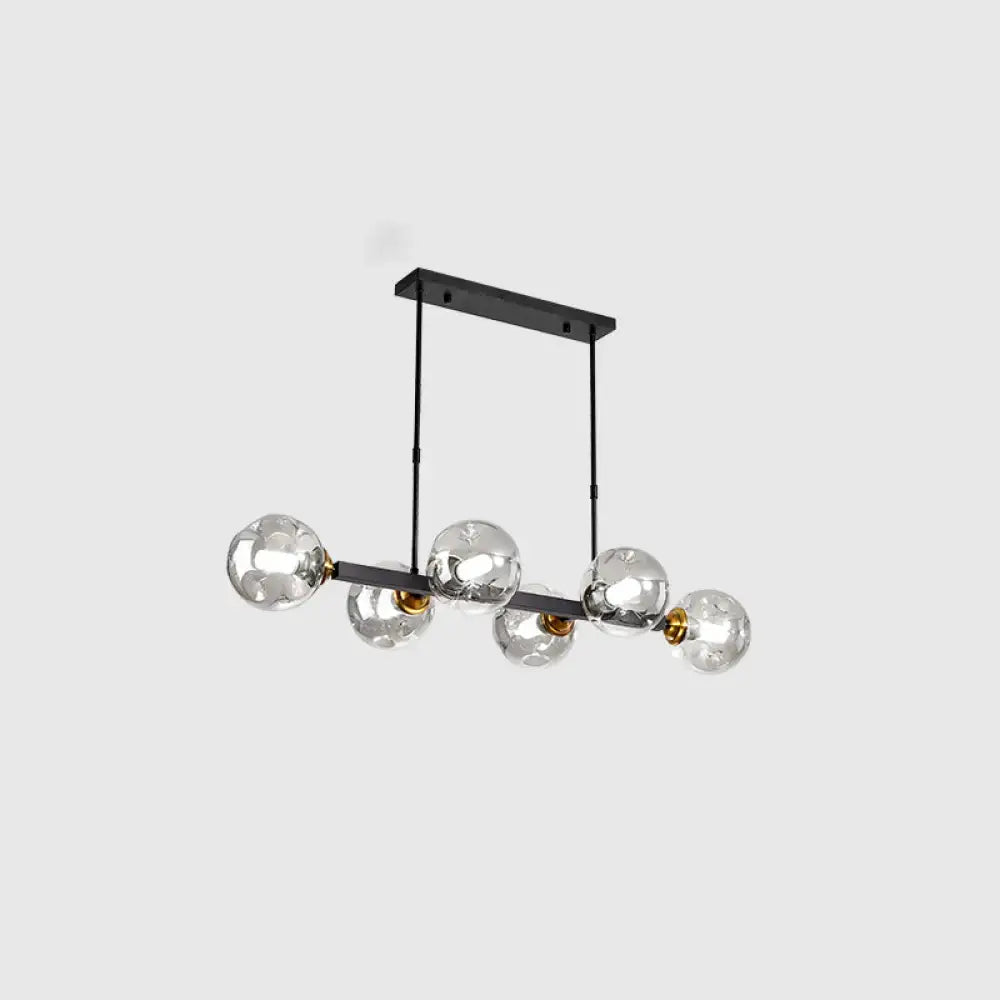 Modern black metal chandelier with five hand-blown dimpled glass globes and gold-toned accents for restaurant use