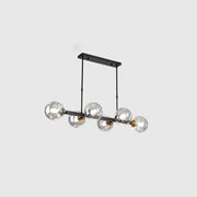 Modern black metal chandelier with five hand-blown dimpled glass globes and gold-toned accents for restaurant use