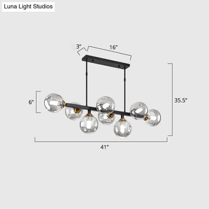 Modern black metal chandelier with six clear hand-blown dimpled glass globe bulbs and gold-toned accents for restaurant use
