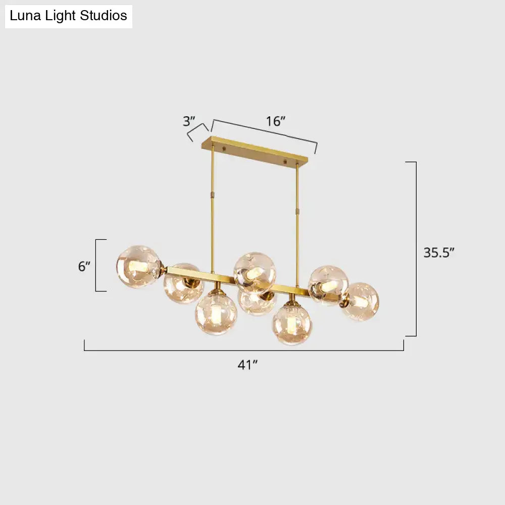 Gold-toned decorbites hand-blown dimpled glass chandelier with multiple spherical bulbs for modern restaurant use