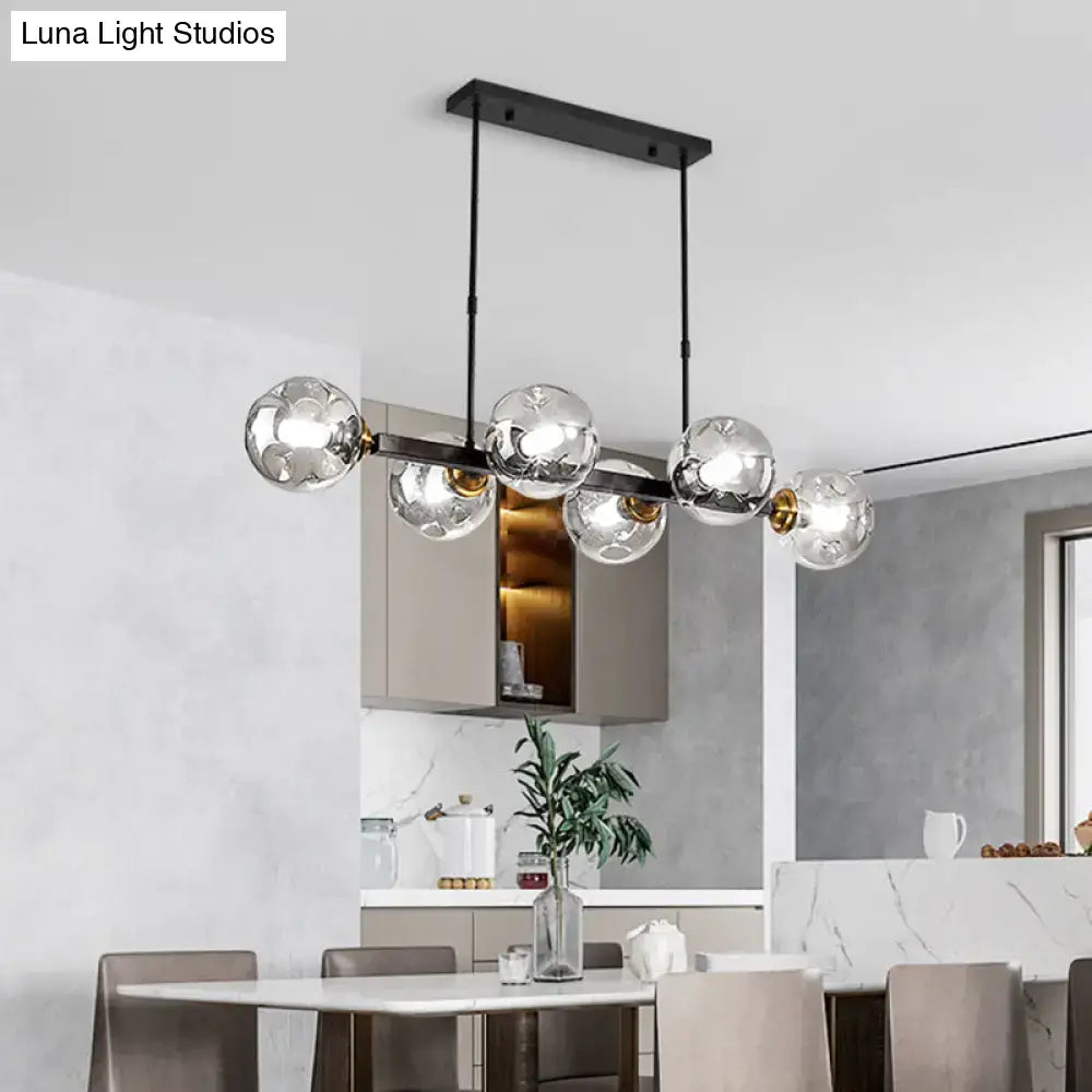 Modern black metal chandelier featuring five clear hand-blown dimpled glass globe bulbs for restaurant use