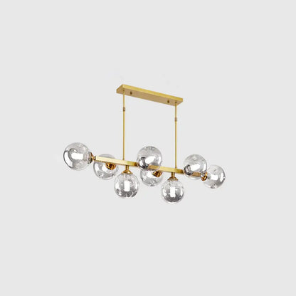 Modern gold-toned decorbites™ island pendant lamp with hand-blown dimpled glass globe bulbs for restaurant lighting