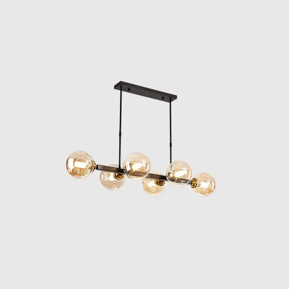 Modern black metal chandelier with five warm-toned hand-blown dimpled glass globe bulbs for restaurant use