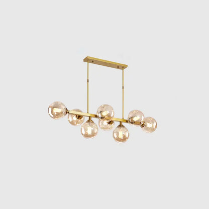 Gold-toned DecorBites™ modern chandelier with seven hand-blown dimpled glass amber bulbs for restaurant island lighting