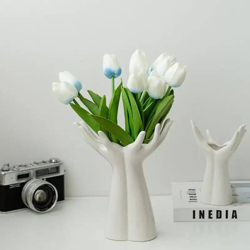 Decorbites™ hand-painted white ceramic vase shaped like two hands cradling white tulips with blue-tipped petals arm palm