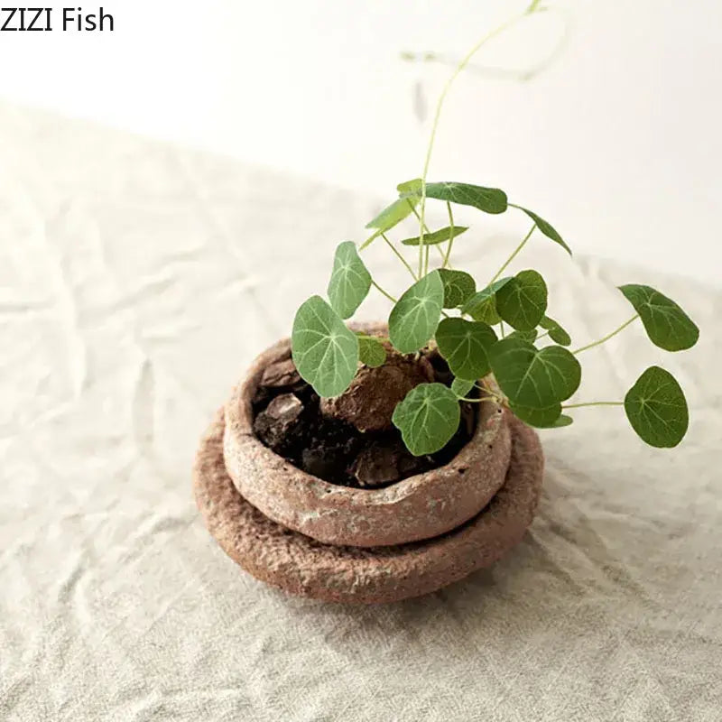 DecorBites™ handcrafted ceramic vase terracotta pottery vase with textured layered design holding a small green plant