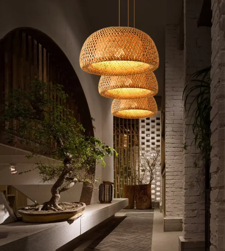 DecorBites™ handcrafted warm-toned three tiered woven bamboo pendant lamp in a modern interior setting