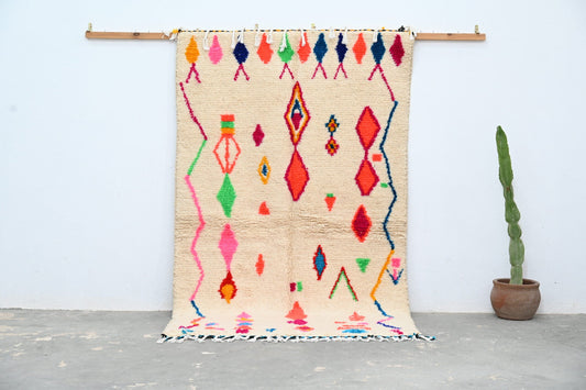 Beige moroccan azilal rug with vibrant pink red green blue and orange geometric patterns handcrafted 246 x 146 cm