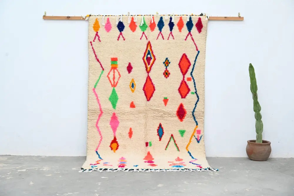 Beige moroccan azilal rug with vibrant pink red green blue and orange geometric patterns handcrafted 246 x 146 cm