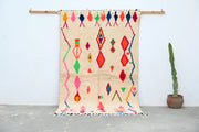 Beige moroccan azilal rug with vibrant pink red green blue and orange geometric patterns handcrafted 246 x 146 cm