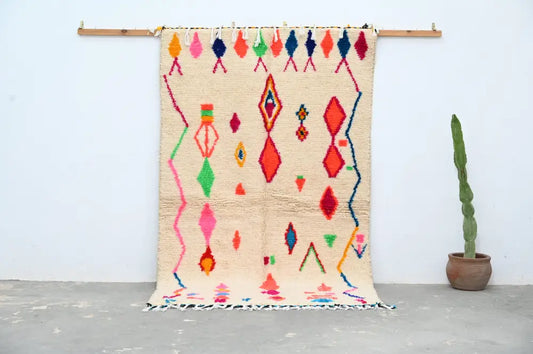 Beige moroccan azilal rug with vibrant pink red green blue and orange geometric patterns handcrafted 246 x 146 cm