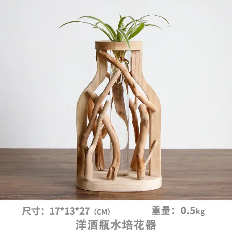 A rustic handcrafted wooden vase with natural driftwood branches and a small green plant for home decor