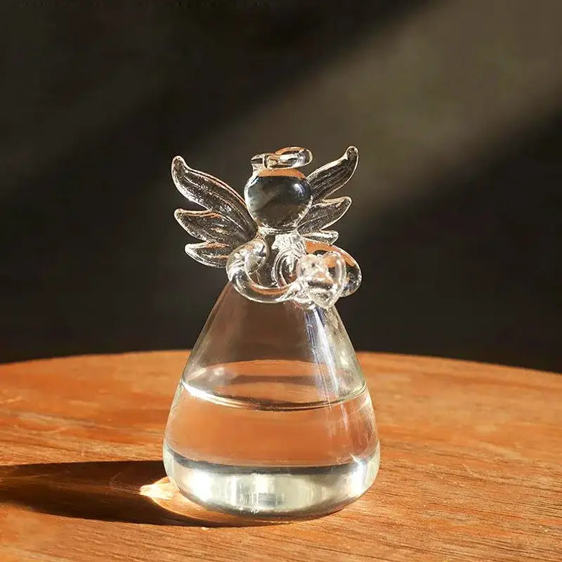 Clear glass angel vase by DecorBites with transparent wings and glossy black head holding heart ornament for home decor