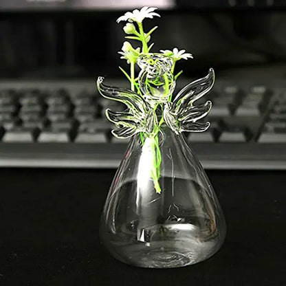 DecorBites handmade clear glass angel vase with delicate wings and floral design holding small white daisies