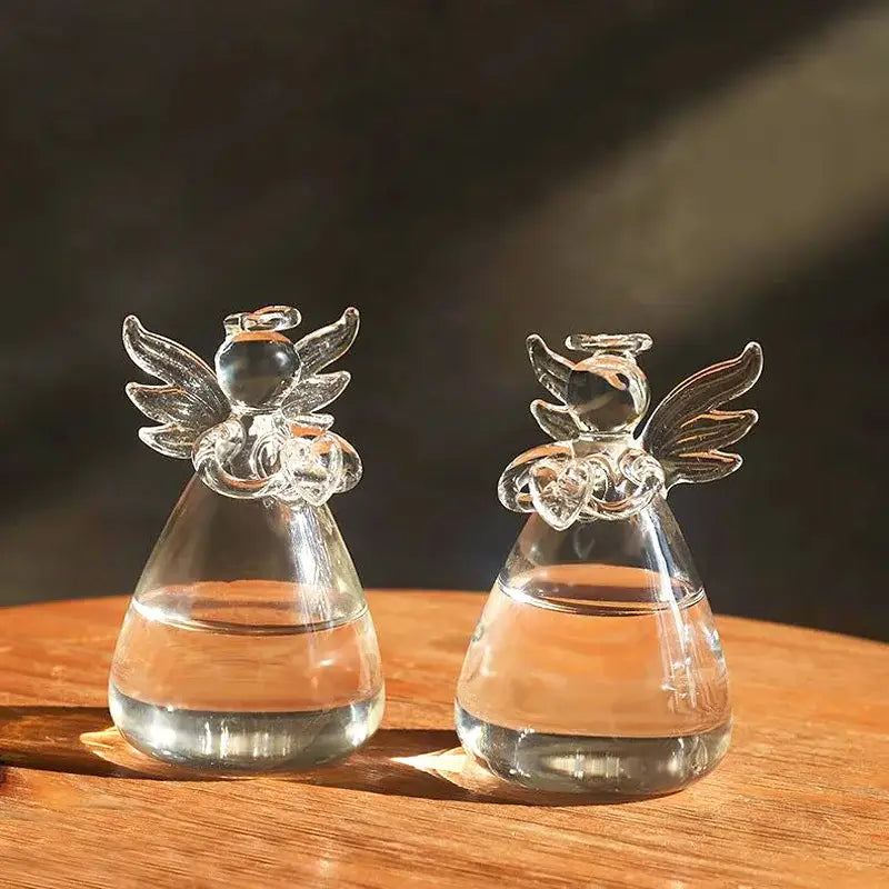 Decorbites™ handmade angel glass vases with clear glass, delicate wings and halos, holding amber-colored liquid
