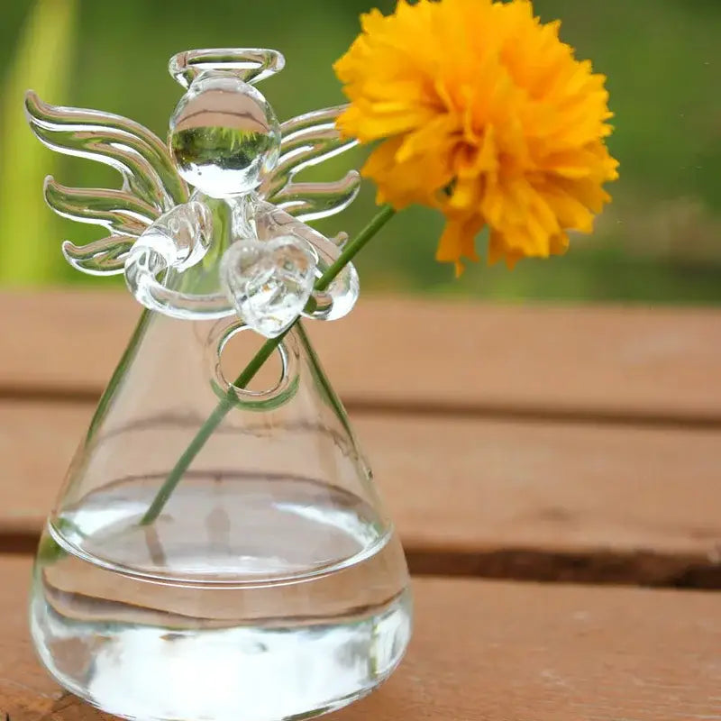 DecorBites™ handmade clear glass angel-shaped vase holding a single yellow flower for elegant home decor