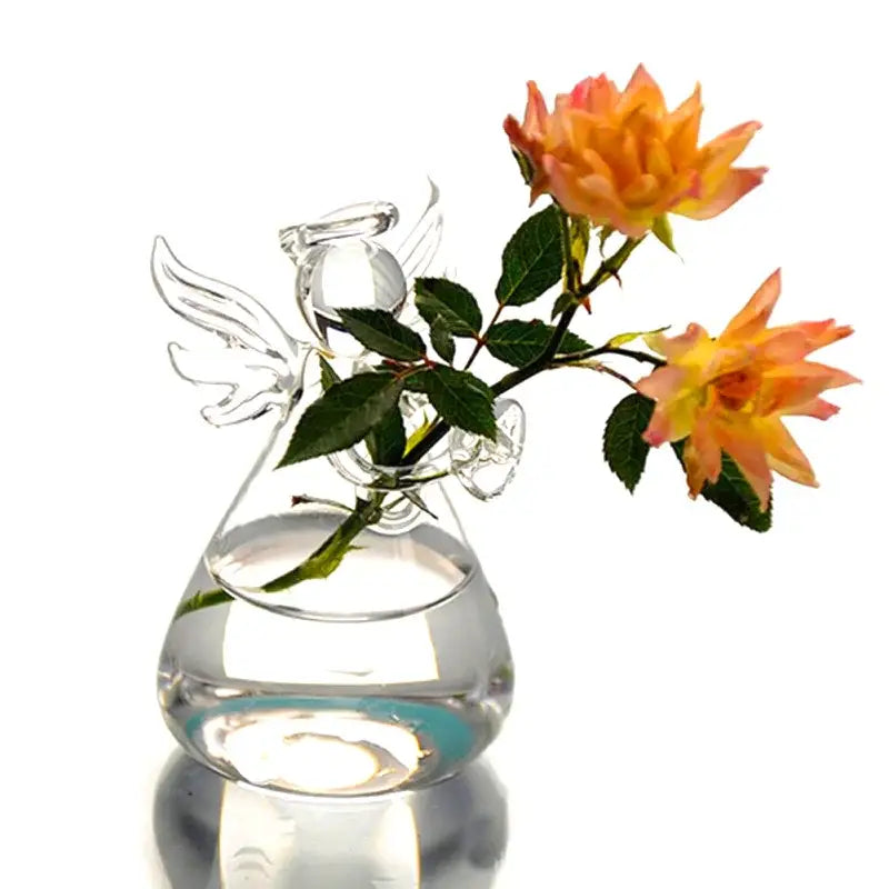 Clear glass angel-shaped vase by DecorBites holding two orange roses for elegant home decor