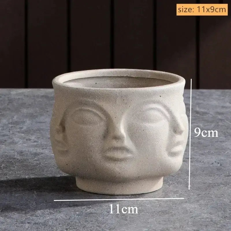 Beige handmade ceramic face vase with three-faced design featuring closed eyes and defined lips for home decor and art vase sculpture