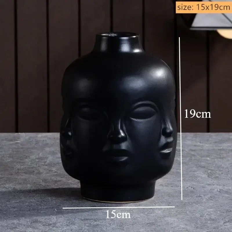 DecorBites™ handmade ceramic face vase in black with three stylized faces for unique home decor art vase sculpture
