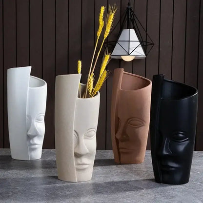 Four handmade ceramic face vases with stylized human faces and split-open design for unique home decor art vase sculpture